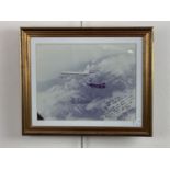 A framed photograph of a US Air Force F-111 Aardvark jet aircraft flying out of RAF Upper Heyford,