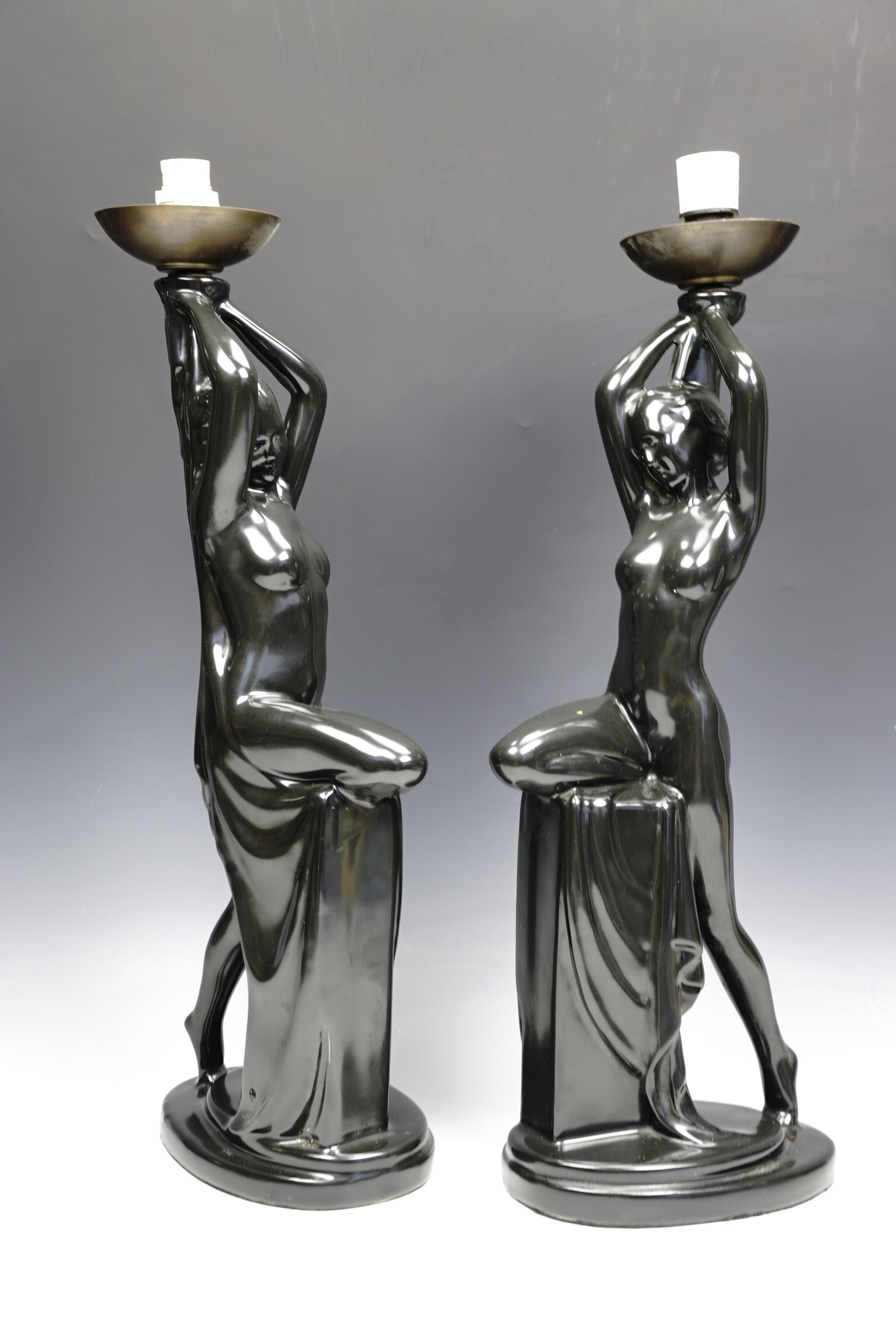 A pair of Art Nouveau influenced black glazed ceramic figural table lamps, 52 cm