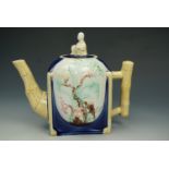 A late Victorian Majolica teapot, body formed as a round set into a square, decorated in relief