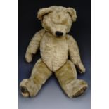 A vintage golden plush Teddy bear, articulated and apparently having a growler mechanism (a/f),
