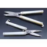 Two sets of Victorian folding scissors, having mother-of-pearl grips scales