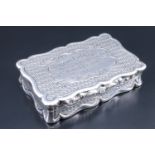 A Victorian silver pocket snuff box, of cusped form, engine turned and scroll-moulded, its lid