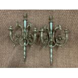 An impressive pair of Louis XVI style gilt metal two-branch candle brackets