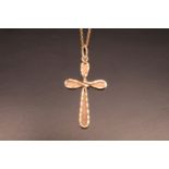 A 1970s 9 ct gold pendant cross, of faceted interlace form, 3 cm excluding suspender, on a fine link