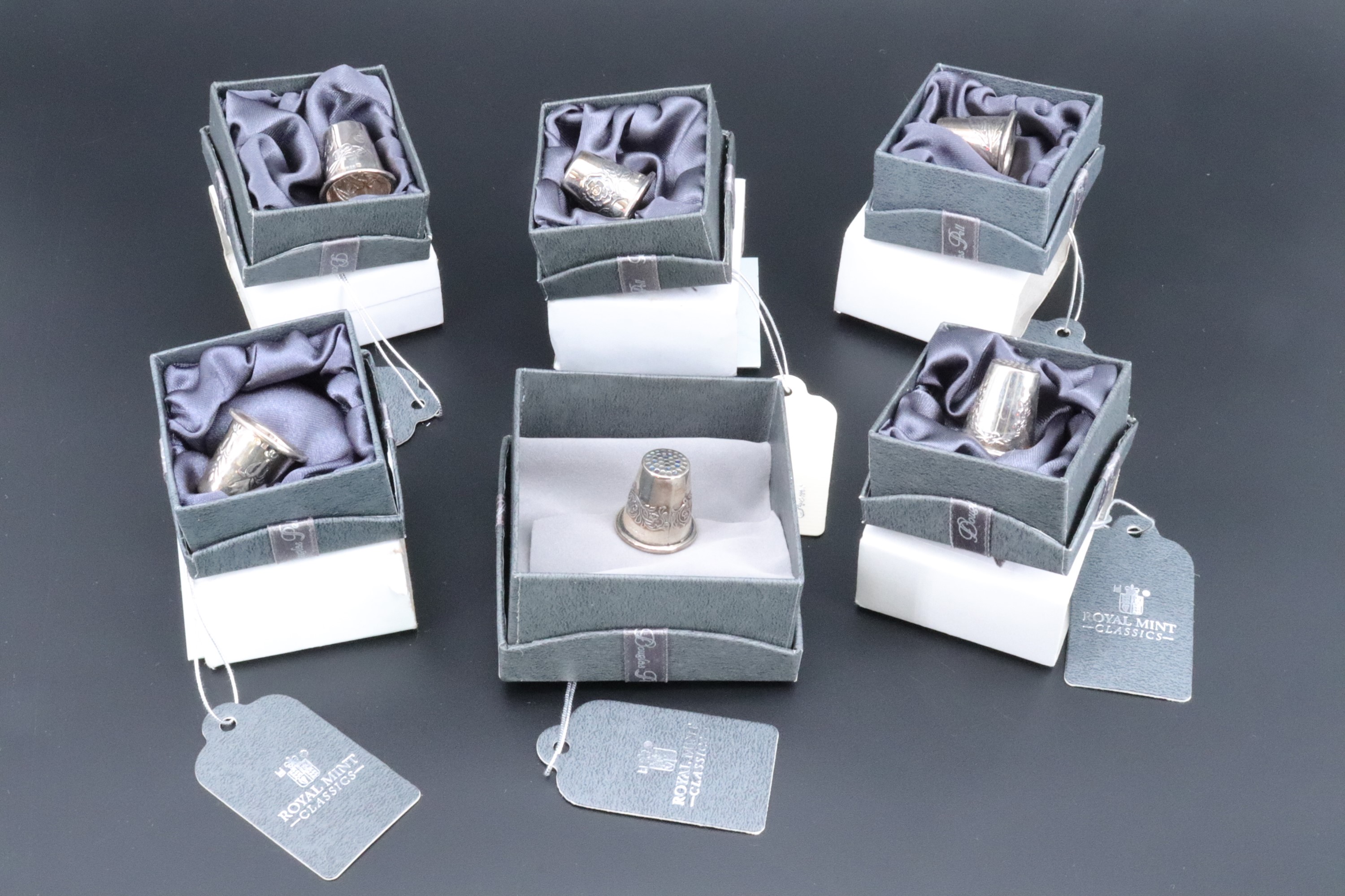 A set of Royal Mint Classics countries of the United Kingdom silver thimbles, tagged and boxes as-