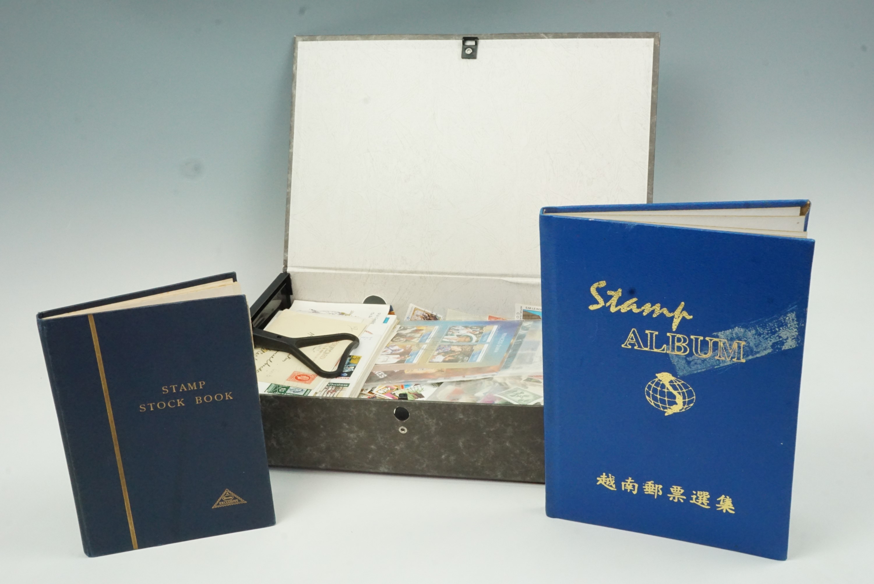 A box file containing a stamp album and sundry philatelic material