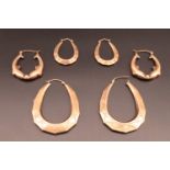 A large pair of 9 ct gold hoop earrings, a smaller yellow metal pair and others in 9 ct gold