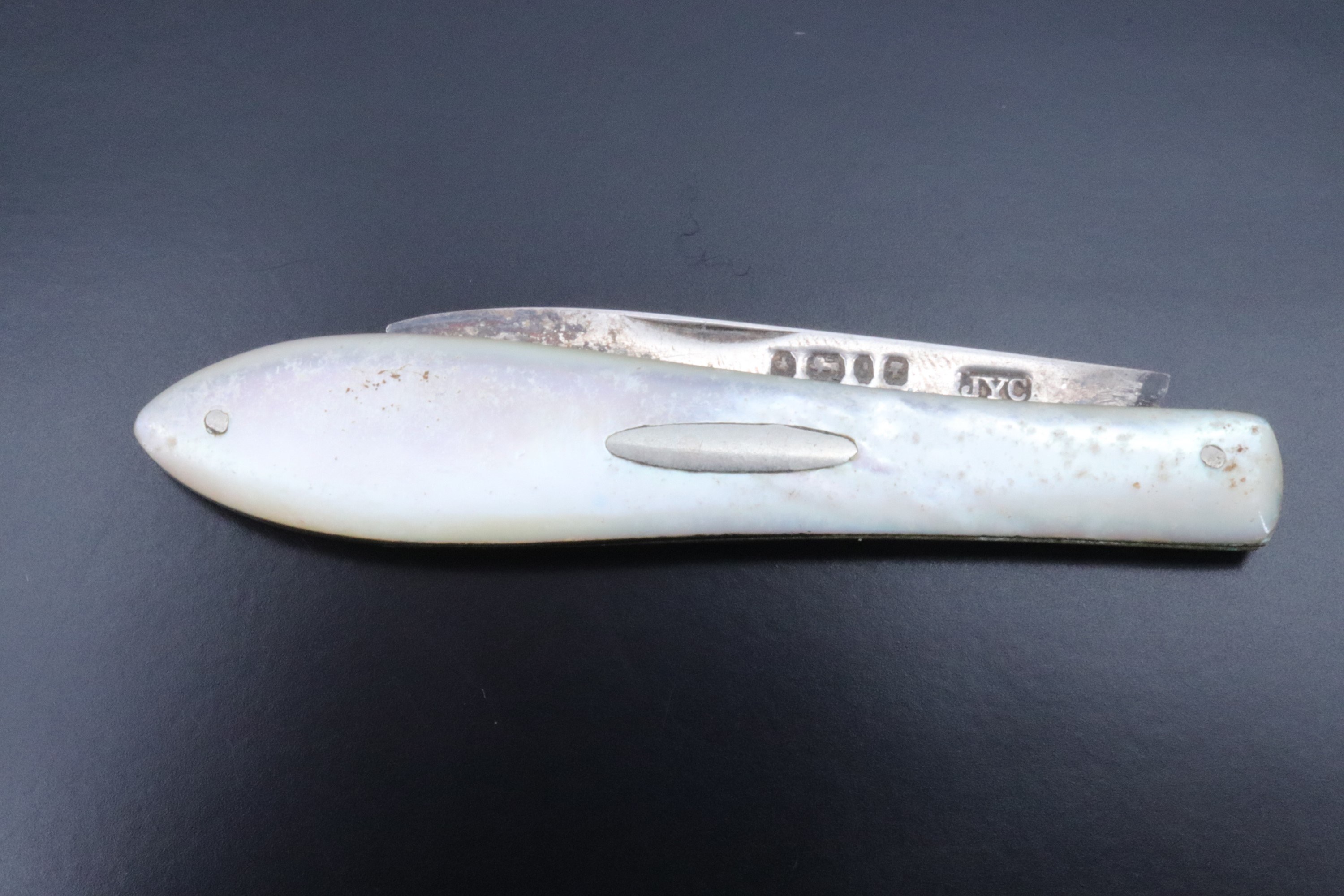 A Victorian pocket folding fruit knife, having mother-of-pearl grip scales and a silver blade,