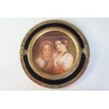 A print after a 19th Century romantic oil painting as two young women, in a decorative circular