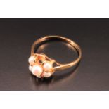 A 9 ct gold and pearl cluster set ring, having a central pearl elevated above six smaller stones