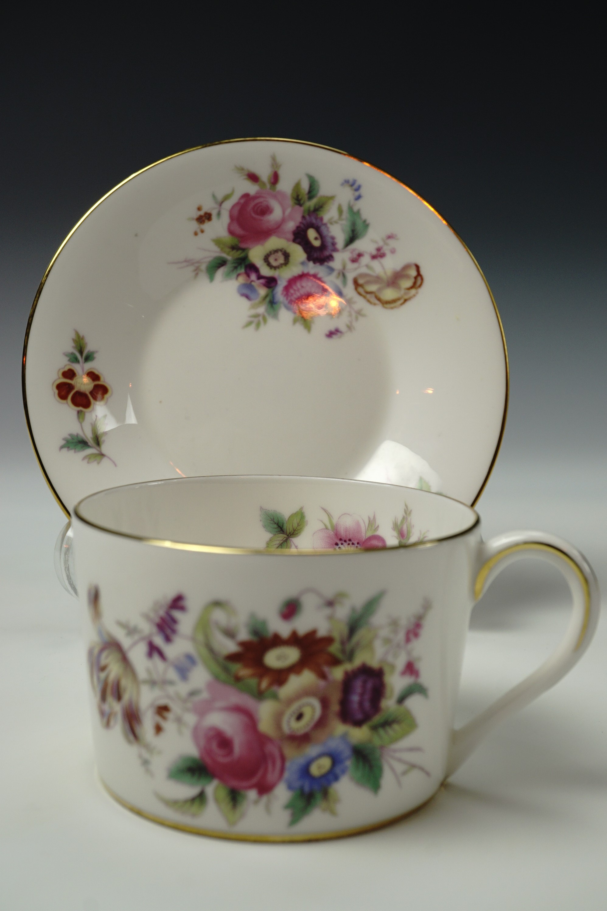 Six Coalport 'Junetime' teacups and saucers, white body with polychrome floral decoration inside and