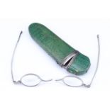 A Georgian green shagreen covered and white metal mounted spectacles case, containing a set of