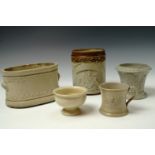 A small buff coloured stoneware cachepot, having moulded decoration of acanthus leaves and