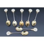 Seven 1960s enamelled silver coffee spoons, having a white and green enamel and parcel gilt York