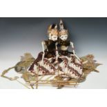 Two Indonesian Wayang Golek puppets together with a pair of shadow puppets, former approx 65 cm