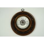 An early 20th century carved oak wheel barometer, 20 cm