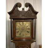 An 18th Century brass-faced long case clock in a later-carved oak case, 197 cm
