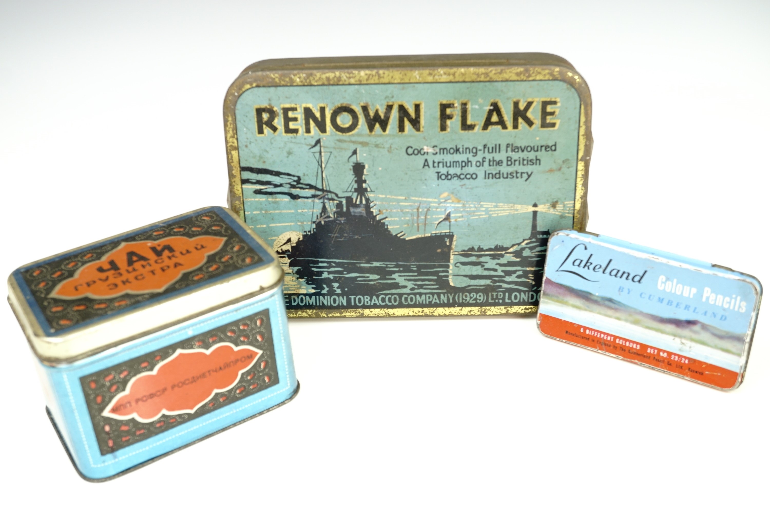 A vintage Russian tinplate box containing original tea, a 1920s Renown Flake tin and another