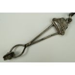 A Victorian lady's electroplate skirt lifter, its terminal modelled as a bonnet, 15 cm