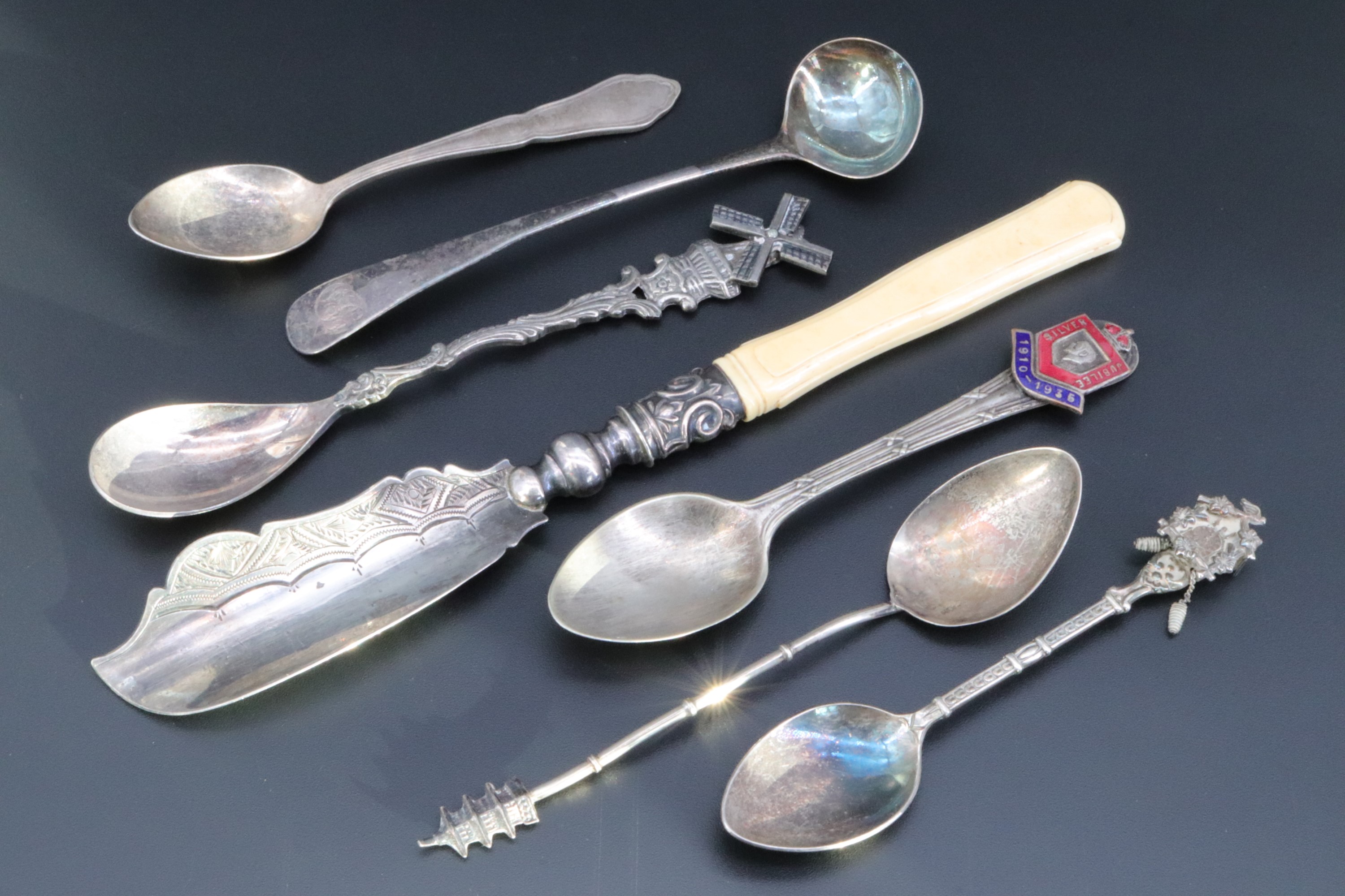 A Georgian silver salt spoon, a Victorian silver butter knife and sundry other spoons