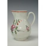 An 18th century baluster shaped sparrow beak cream jug, having polychrome enamel floral
