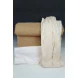 A quantity of white and cream fabric, comprising part rolls and off cuts, including hand woven
