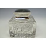 An early 20th Century silver and cut glass inkwell, of square form with a cut base, square silver
