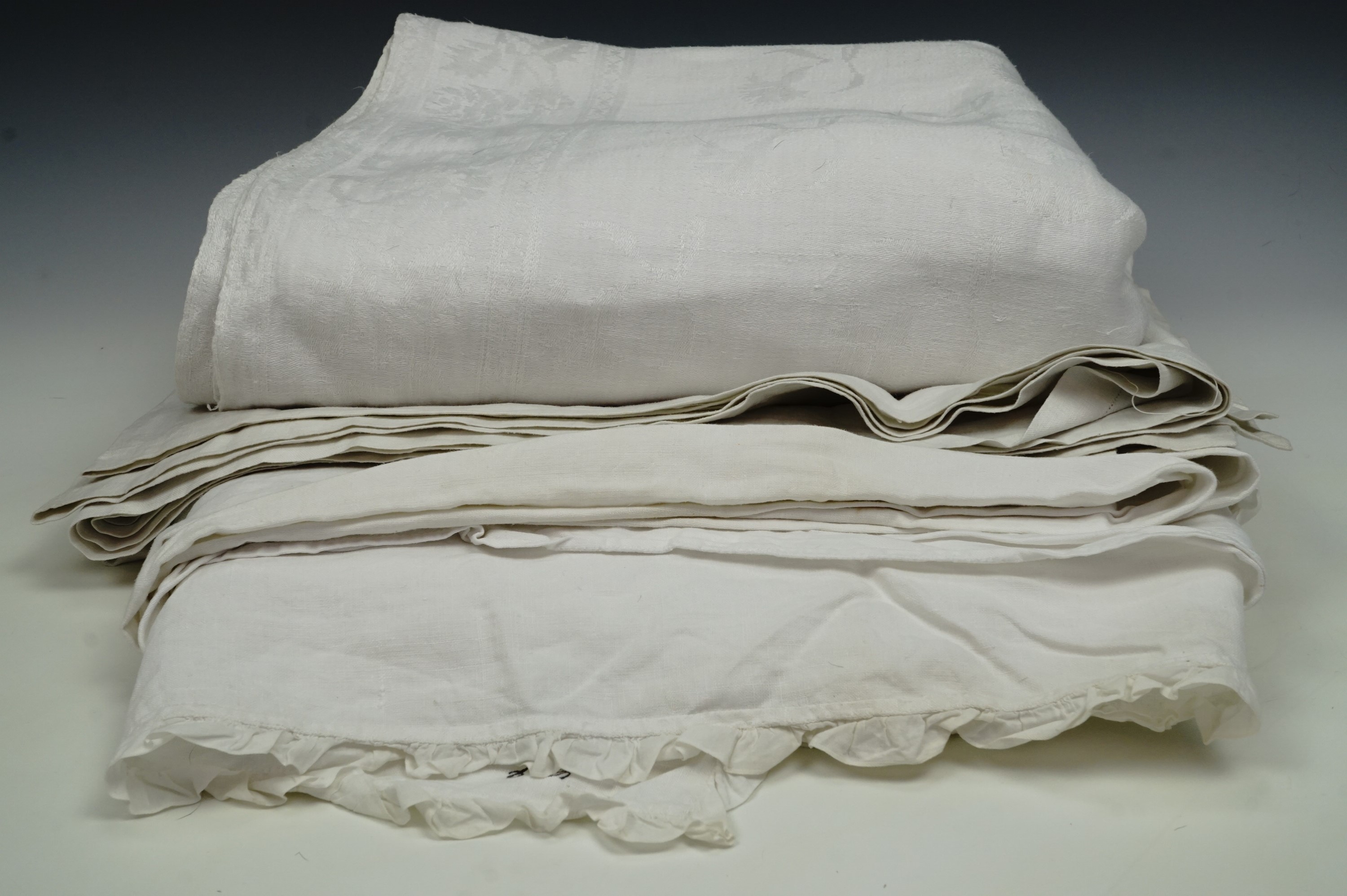 Two tablecloths and a bed sheet