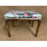 A 1930s carved and upholstered walnut dressing table stool