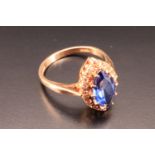 A 1960s sapphire ring, having a blue marquis cut sapphire, on a gallery base set with brilliant
