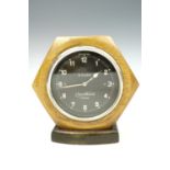 A Cooper Stewart Swiss fascia clock on a turned and ebonised base, face 8 cm, second quarter 20th