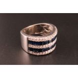 An impressive contemporary 18 ct white gold diamond and sapphire half hoop eternity ring, having two