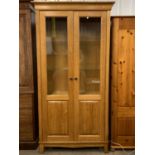 A quality contemporary glazed oak display cabinet