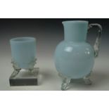 A Victorian blue glass water carafe and a conforming beaker with hot worked feet and handle, jug