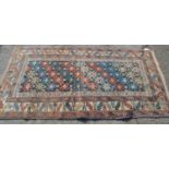 Kazak rug, the centre panel with repeating rosette design on a dark ground with multiple borders,