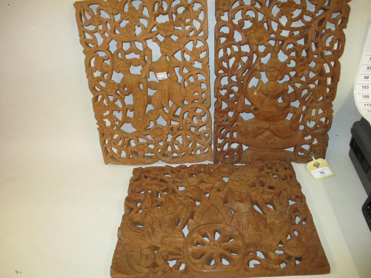 Group of three Indonesian carved and pierced hardwood panels of figures, 10ins x 14ins each