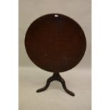 George III mahogany circular pedestal table, the tilt top above a turned wrythen baluster column