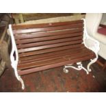 Near pair of white painted cast alloy and wooden slatted garden benches together with a similar