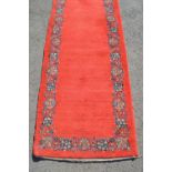 Unusual mid 20th Century central Persian runner, the plain red field with a repeating floral border,