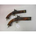 Near pair of small 19th Century percussion pistols with integral ramrods and lanyard rings, engraved