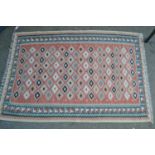 Small Kelim rug with an all-over flower head design on a salmon pink ground with borders, 4ft 8ins x