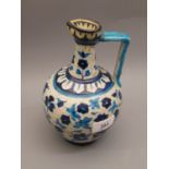 Iznik salt glazed pottery jug with blue floral painted decoration (restored) 8ins high,5ins