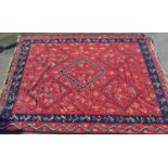 Large Kelim carpet with a five medallion and all-over floral stylised design on a red ground with