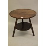 Circular ash, elm and sycamore cricket type table, the dish top above turned supports and undertier,