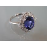 18ct White gold oval natural tanzanite and diamond cluster ring, the tanzanite of approximately 3.