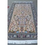 Modern Qum style rug with a tree of life design on an ivory ground with floral borders, 8ft 6ins x