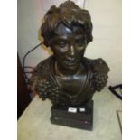 Brown patinated bronze bust of a boy with grape vine collar mounted on a composite pedestal base,