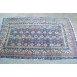 Small Shirvan rug with a repeating hooked medallion and rosette centre panel with blue ground and