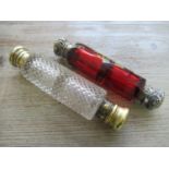 Victorian cranberry glass double ended scent bottle with embossed silver covers, together with a cut