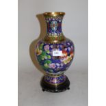 20th Century cloisonne baluster form vase decorated with a floral and bird design on a blue